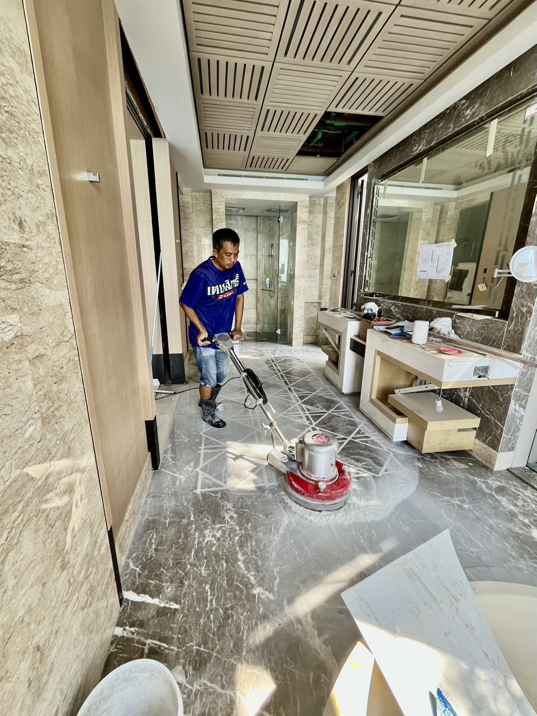 Professional machine repolishing marble floor using rotary polisher Conrad Koh Samui resort